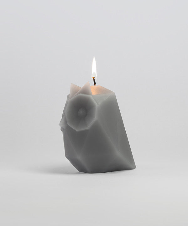 Side view of lit grey ugla the owl pyropet candle